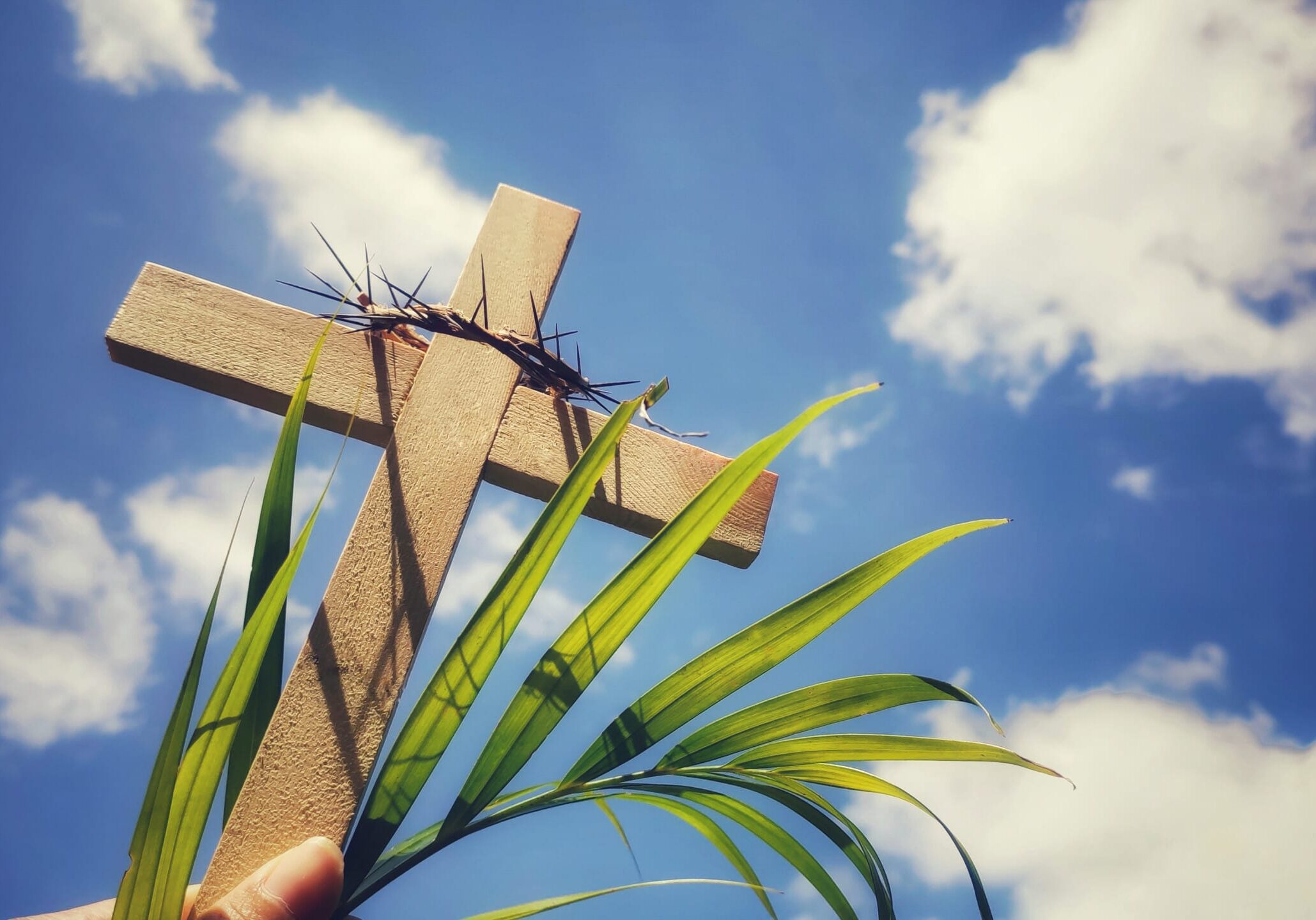 Photo of wooden cross raise up to the sky Stock photo